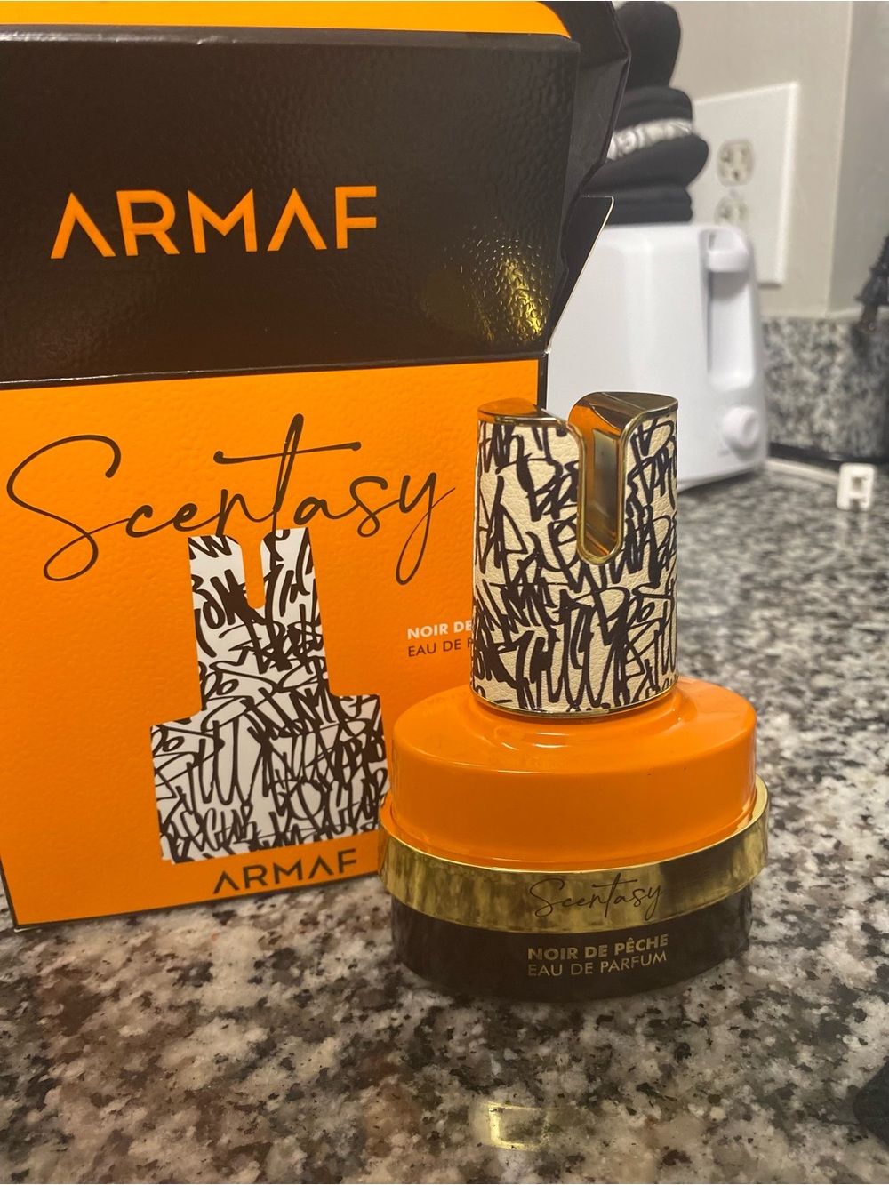 Scentsy Armaf Noir de Pêche Orange and Gold Bottle